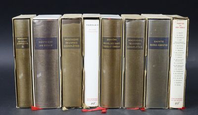six books are lined up in a row on a black surface