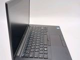 a laptop with a black keyboard sitting on a white surface