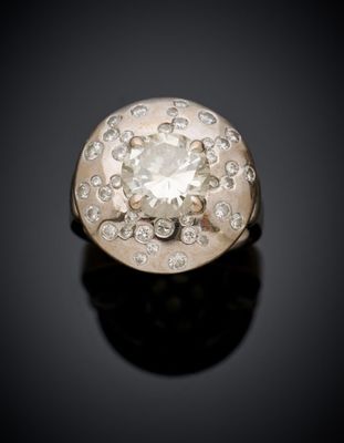 a close up of a diamond ring on a black surface