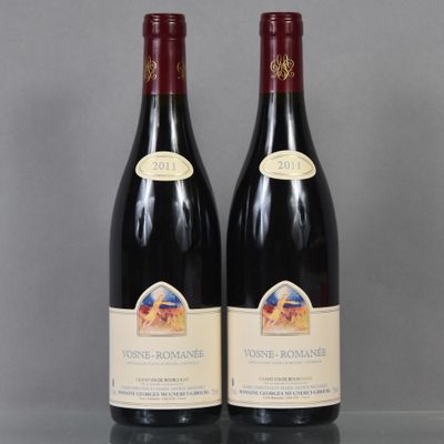 two bottles of wine sitting on top of a table next to each other