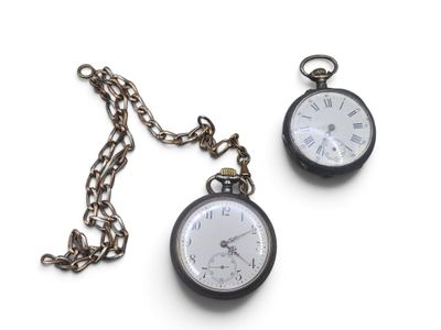 two pocket watches sitting on a chain on a white surface