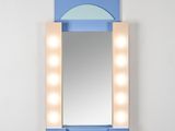 a blue vanity with a mirror and lights on it