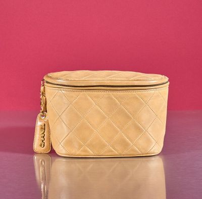an image of a purse on a table with a pink background