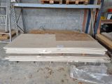 a pile of wood sitting on the floor in a garage