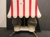a red and white striped awning on top of a table