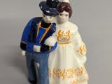 a figurine of a man and a woman standing next to each other