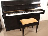 a black piano and a stool in a room