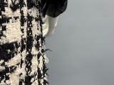 a mannequin wearing a black and white dress with a black and white pattern