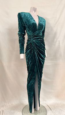 a green velvet dress with long sleeves and a v neckline