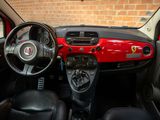 a red and black dashboard and steering wheel of a small car