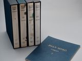 three books are stacked on top of each other on a table