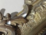 a picture of a gold frame with a bird on it