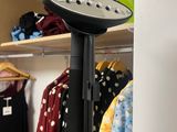 a hair dryer that is on a stand in a closet