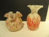two vases that are sitting on a table