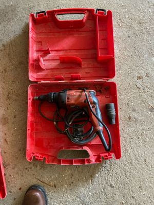 une boîte à outils rouge contenant des outils et une paire de chaussures marron