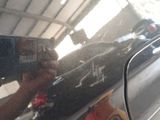 a reflection of a person holding a camera in a car