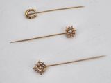 a set of three gold and diamond hair pins