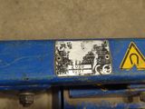 a close up of a blue machine with a sign on it