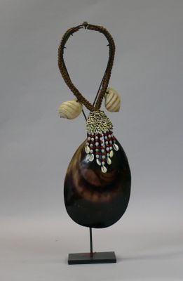 a vase with a long neck and a beaded decoration on it