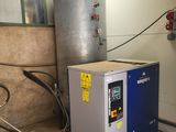 a water heater and a water tank in a room