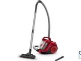 a red vacuum cleaner sitting on top of a white surface