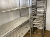 a metal rack with shelves in a kitchen next to a tiled floor