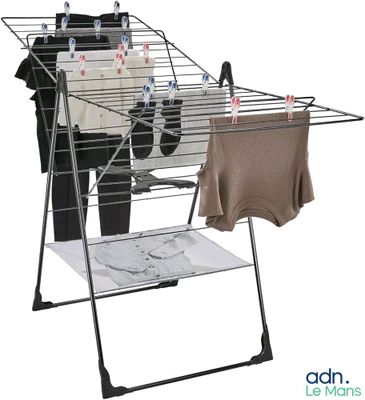 an image of a clothes drying rack with clothes hanging on it