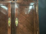 a wooden cabinet that has a door on top of it