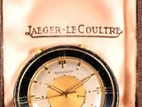 an image of a gold and black watch in a box
