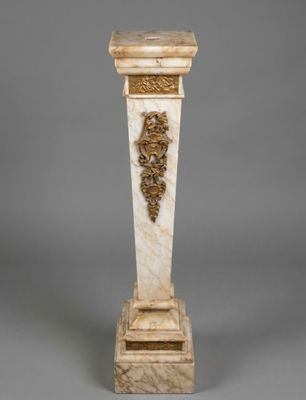 an image of a marble pedestal with a lion head on it