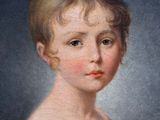 portrait of a young girl in a white dress with a red bow