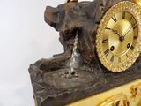 a statue of a dog drinking water from a fountain