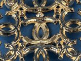 a gold brooch on a blue surface