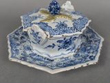 a blue and white plate with a blue flower on it