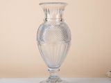 a clear glass vase sitting on a white table