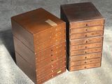 two small wooden drawers sitting next to each other on the floor