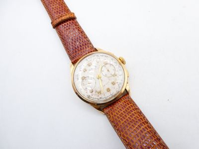 a close up of a wrist watch on a white surface