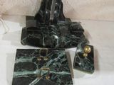 a black and green marble clock on a white table