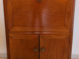 a wooden cabinet with a mirror on top of it