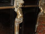 a black desk with a gold statue on top of it