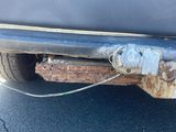 a close up of a rusted bumper on a car