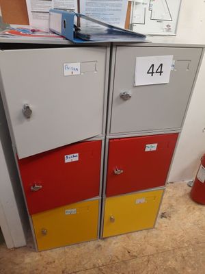 a stack of lockers in a room with a fire hydrant in the background