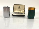 three different types of lighters are sitting on a white surface