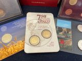 some books and coins are sitting on a table with other books
