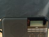 an image of a black radio sitting on top of a wooden table