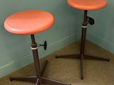 two stools that are sitting in the corner of a room