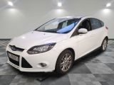 the white ford focus is parked on a checkered floor