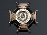 a badge on the back of a badge on a black background