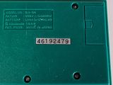 a green electronic device that is sitting on a table