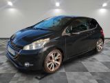 a black car is parked in a room with a checkered floor